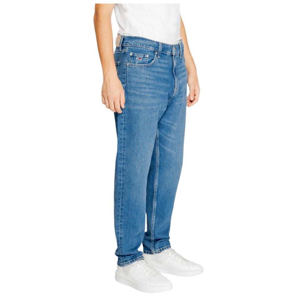 Men wearing Tommy Hilfiger blue jeans made from recycled cotton, fall/winter collection, showing sustainable fashion choice.