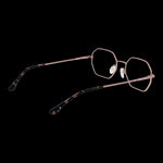 Alt Tag: BULGET MOD. BGY1007 5505A unisex eyeglasses with unique geometric frames in pink, side view on a black background.