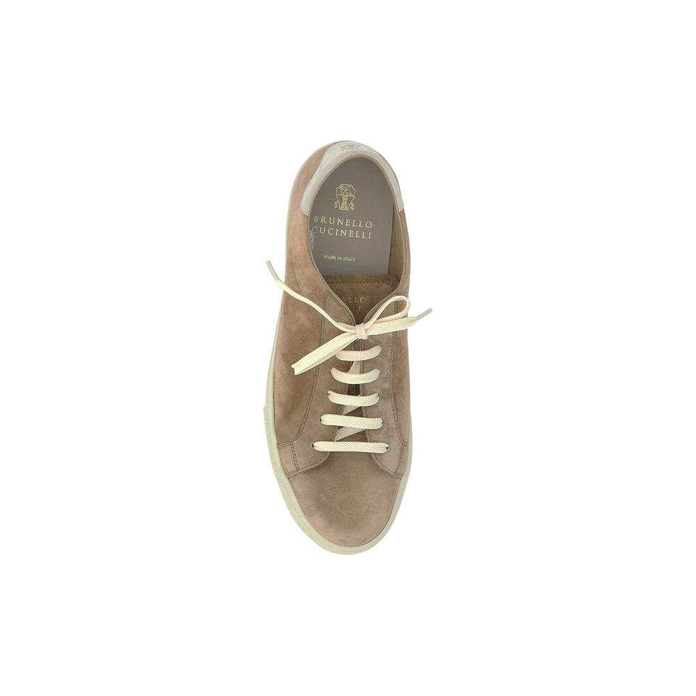 Brunello Cucinelli SneakersCalfskin Snekaers by Brunello Cucinelli featuring a round toe front, a suede design, a lace-up front fastening, a contrasting signature brand print label at the heel, and a branded insole.