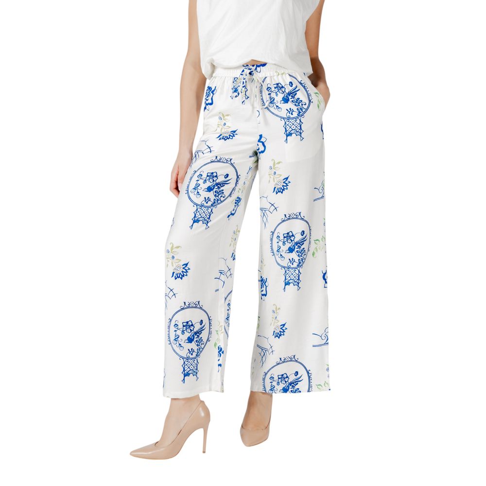 Woman wearing ICHI White Viscose Pant with floral design, wide-leg style, ideal for casual chic or formal occasions, perfect in warm weather.