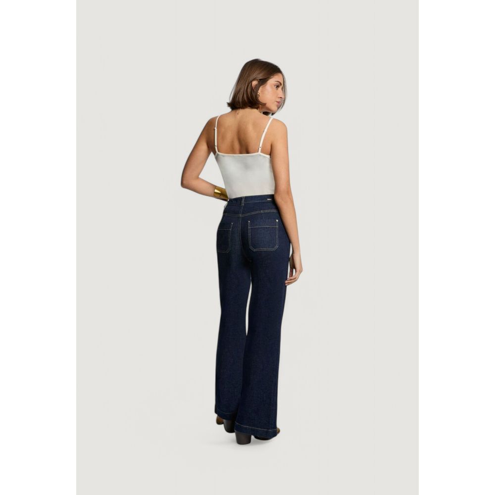 Back view of a woman wearing Morgan De Toi Cream Cotton Tank Tops with dark jeans.