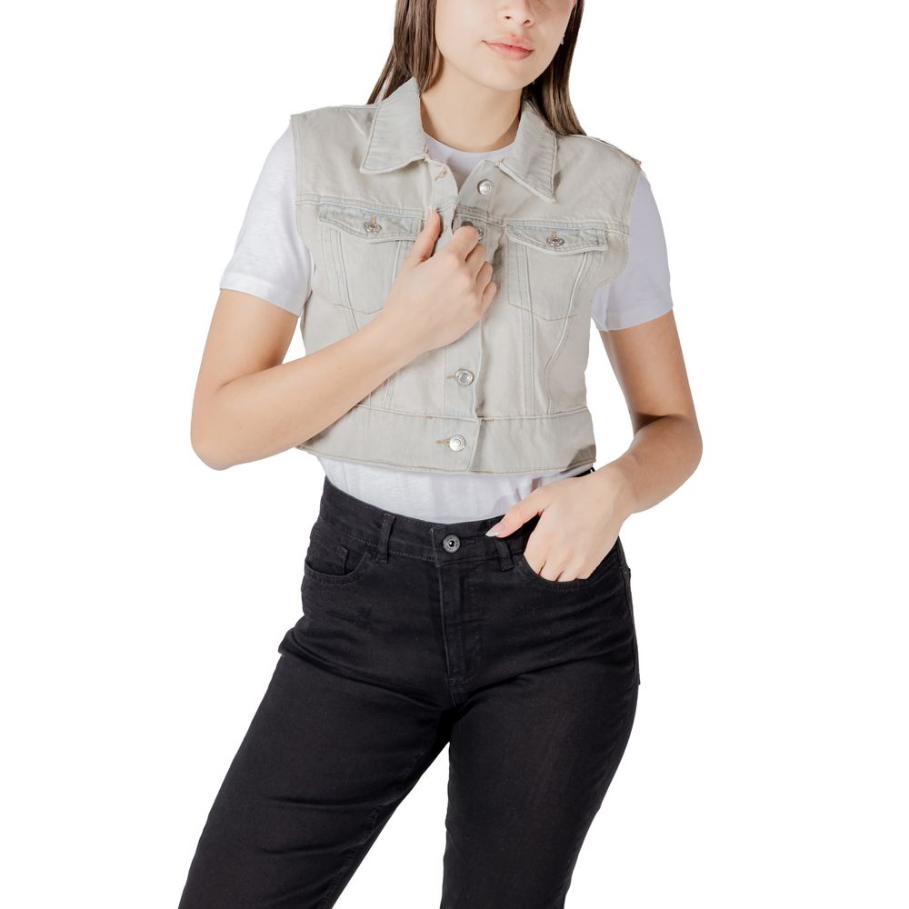 Woman wearing Only Light Blue Cotton Sleeveless Jacket over a white t-shirt and black pants.