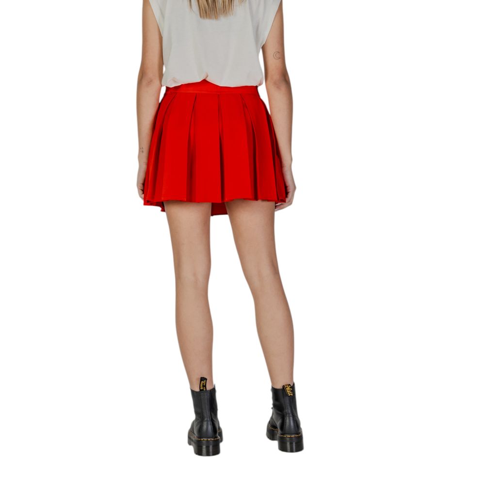Back view of Only Red Recycled Polyester Mini Skirt with pleats and elastic waistband, styled with black boots.