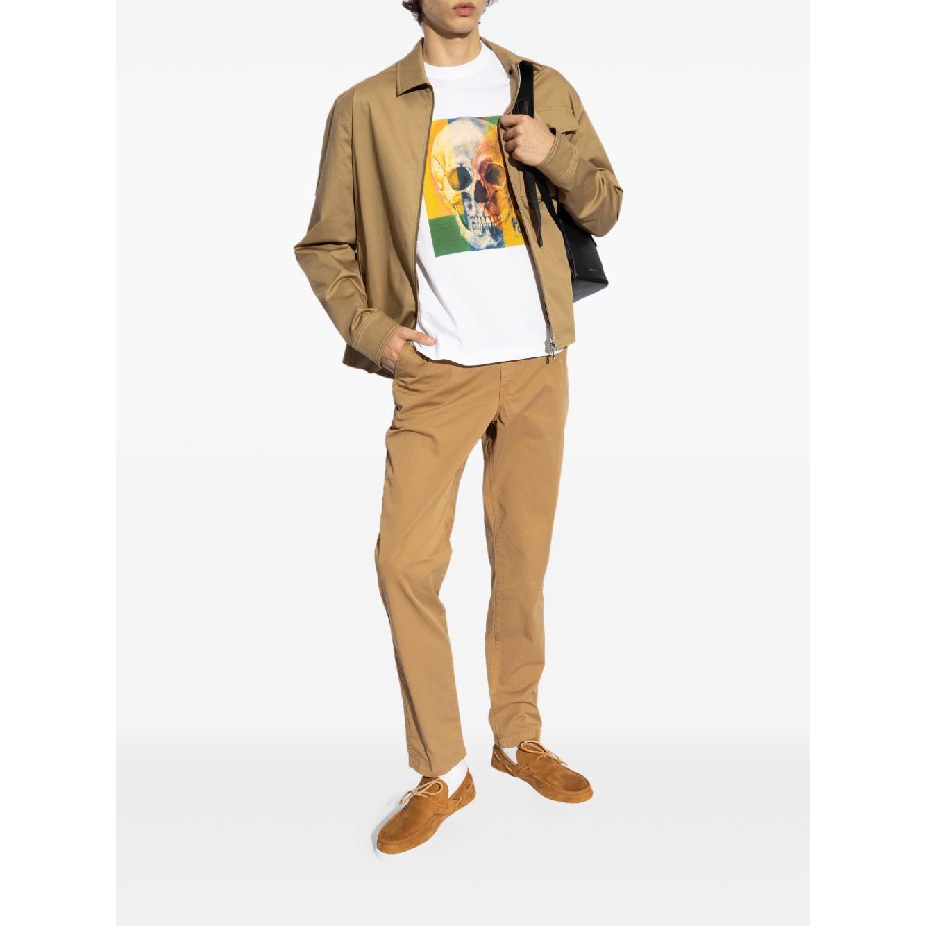 Model wearing PS By Paul Smith T-shirts and Polos White with skull print, brown jacket, and pants, showcasing casual style.