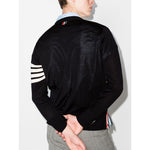 Rear view of model wearing Thom Browne Sweaters Blue with signature 4-Bar stripe and RWB detail, navy blue merino wool cardigan.
