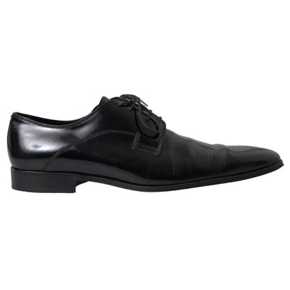Dolce & Gabbana Black Polished Leather Formal Dress Shoes in polished leather, revealing logo details, slight wear, exclusive craftsmanship, side view.