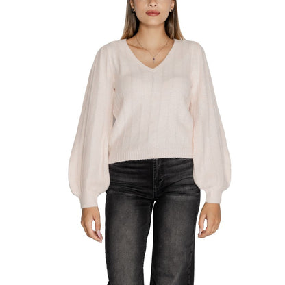 Woman wearing Guess Pink Polyester Sweatshirt with V-neck and wide long sleeves, ideal for autumn-winter fashion.