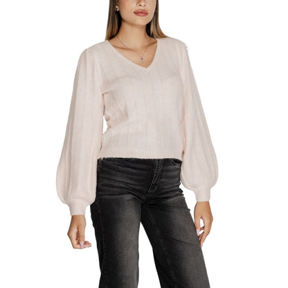 Model wearing Guess Pink Polyester Sweatshirt with ribbed texture and modern V-neckline, paired with dark jeans.