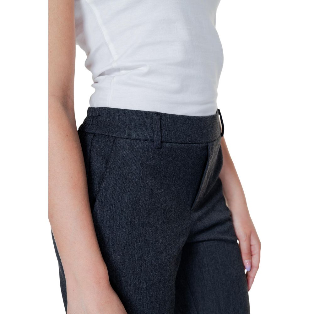 Woman wearing Vero Moda Gray Polyester Casual Pants with a white top, highlighting the comfortable fit and modern design.