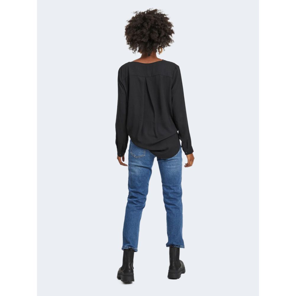 Back view of woman wearing Vila Clothes Black Polyester Blouse with jeans and boots, showcasing versatile fashion style.