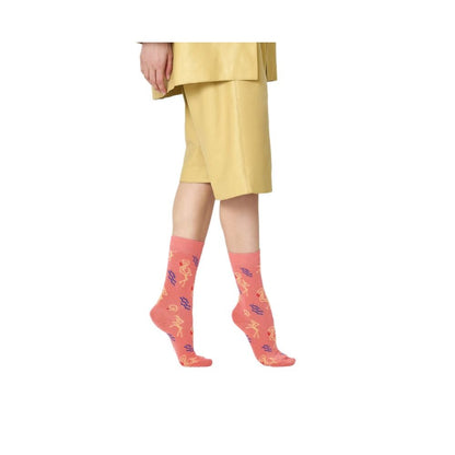 Person wearing Happy Socks Orange Cotton Socks with flamingo pattern, highlighting playful and stylish design.