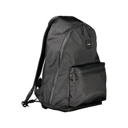 Calvin Klein Black Polyester Men Backpack with sleek design and adjustable straps, featuring a water-repellent exterior and laptop compartment.