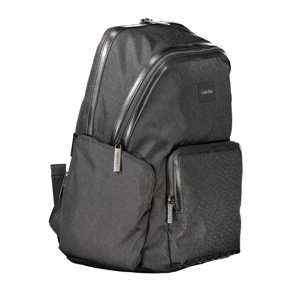 Calvin Klein Black Polyester Backpack with handle, adjustable straps, zip closure, side pockets, laptop compartment, and logo detailing.