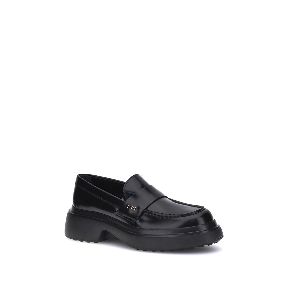 Tod's Black Rubber Platform Loafers with patent leather and rounded toe, featuring a side logo plaque for an elegant design.