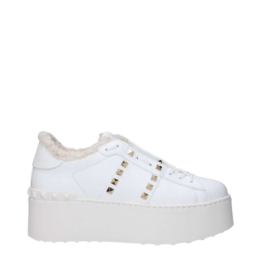 Valentino Garavani White Leather Platform Sneakers with studs, fur lining, and rubber wedge sole, featuring lace-up closure.