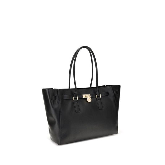 Michael Kors Hamilton Moderne large Tote Bag in black with decorative belt and padlock pendant.