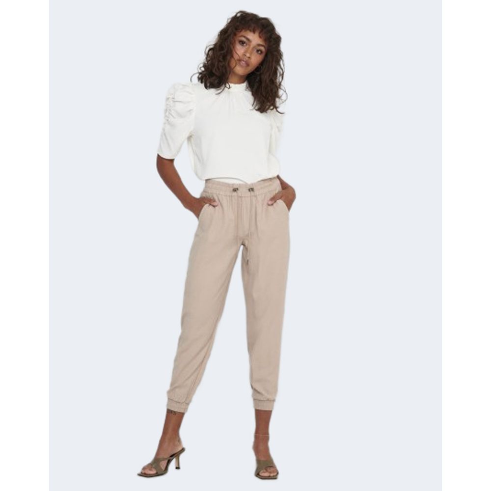 Woman modeling Only Beige Viscose Casual Pants with elastic cuffs and pull-up design, paired with a white top for a stylish look.