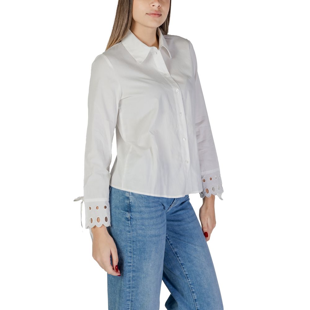 Jacqueline De Yong White Cotton Blouse with long sleeves and cut-out cuffs, shown on a model wearing jeans.