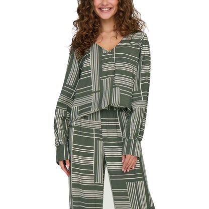 Jacqueline De Yong Green Viscose Blouse with geometric stripes, V-neckline, and long sleeves worn by a smiling woman.