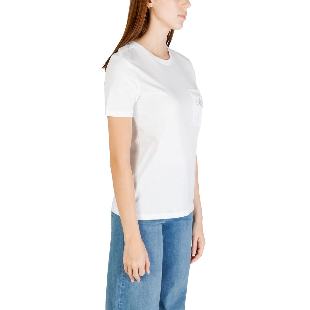 Woman wearing Only White Organic Cotton T-Shirt with short sleeves and pocket detail, paired with blue jeans, side view.