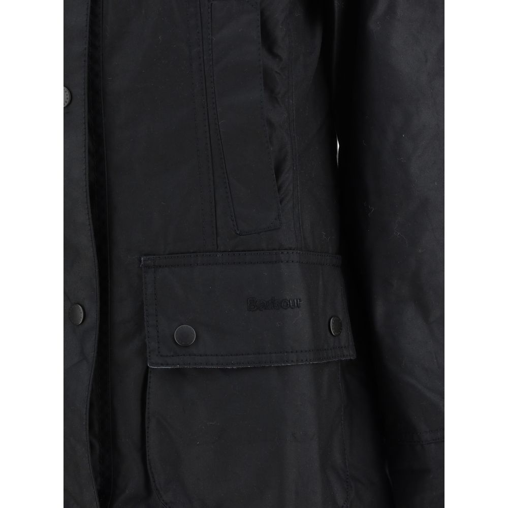 Barbour Black Cotton Coat with waxed finish, zip and press stud fastening, ribbed collar, and patch pockets showcasing iconic Barbour monogram.