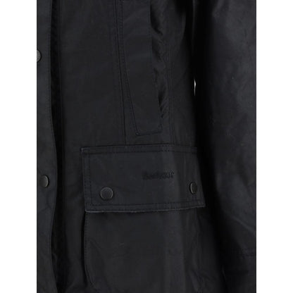 Barbour Black Cotton Coat with waxed finish, zip and press stud fastening, ribbed collar, and patch pockets showcasing iconic Barbour monogram.
