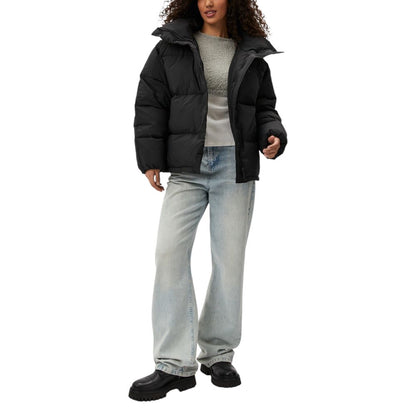 Woman wearing Calvin Klein Jeans Black Polyester Clothing Relaxed Puffer jacket, highlighting modern style and warmth for cold weather.