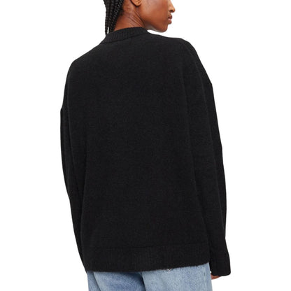 Model wearing Calvin Klein Jeans Black Polyester Sweatshirt with loose fit and long sleeves, ideal for casual winter style.