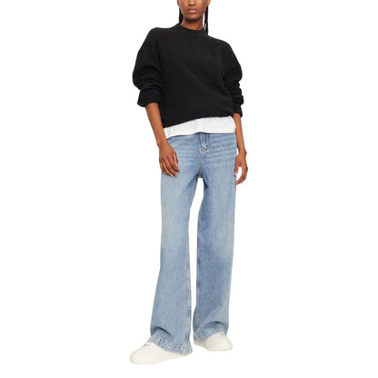 Woman wearing Calvin Klein Jeans Black Polyester Sweatshirt with blue jeans and white sneakers