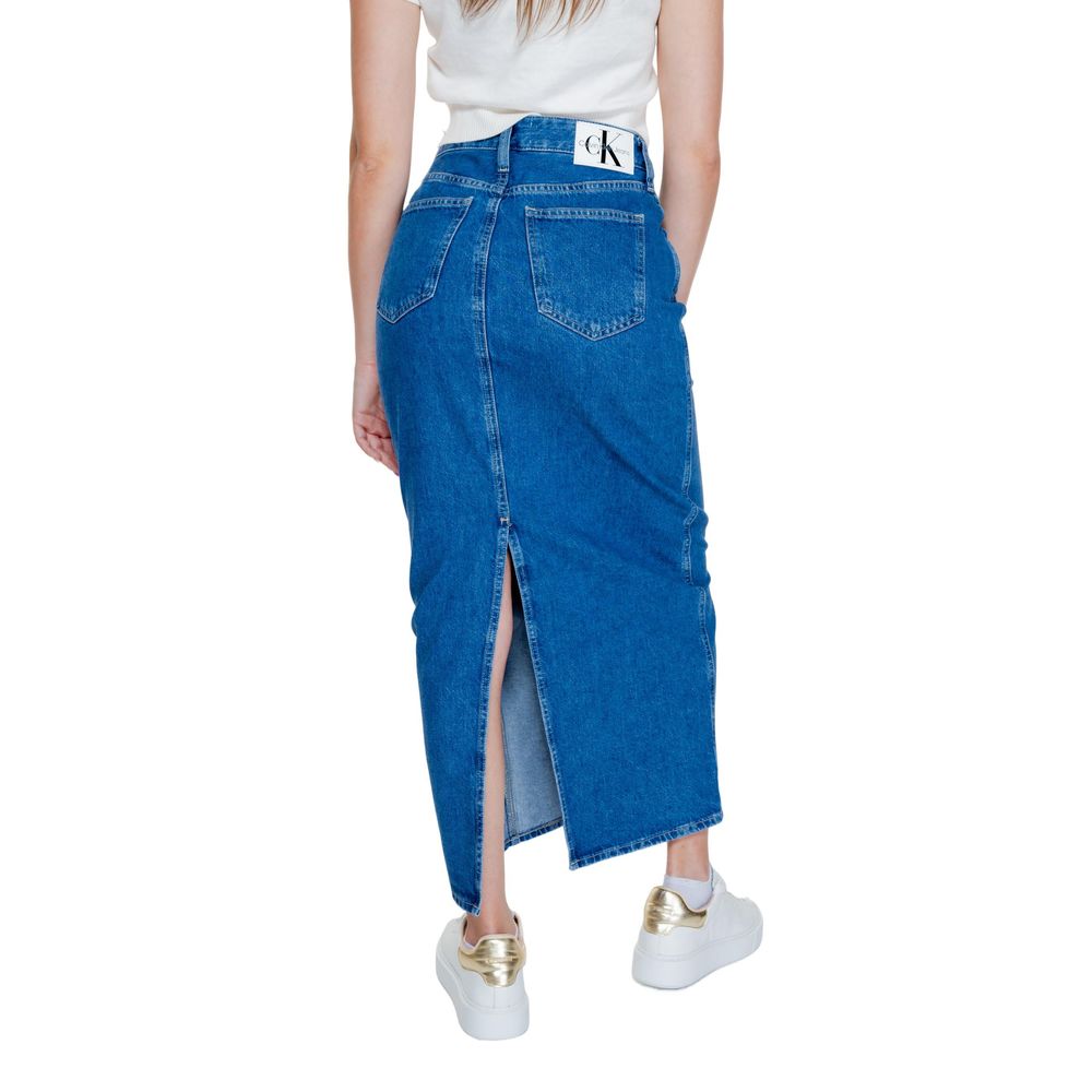 Back view of Calvin Klein Jeans Blue Cotton Long Skirt with pockets and contrast stitching, worn with white sneakers.