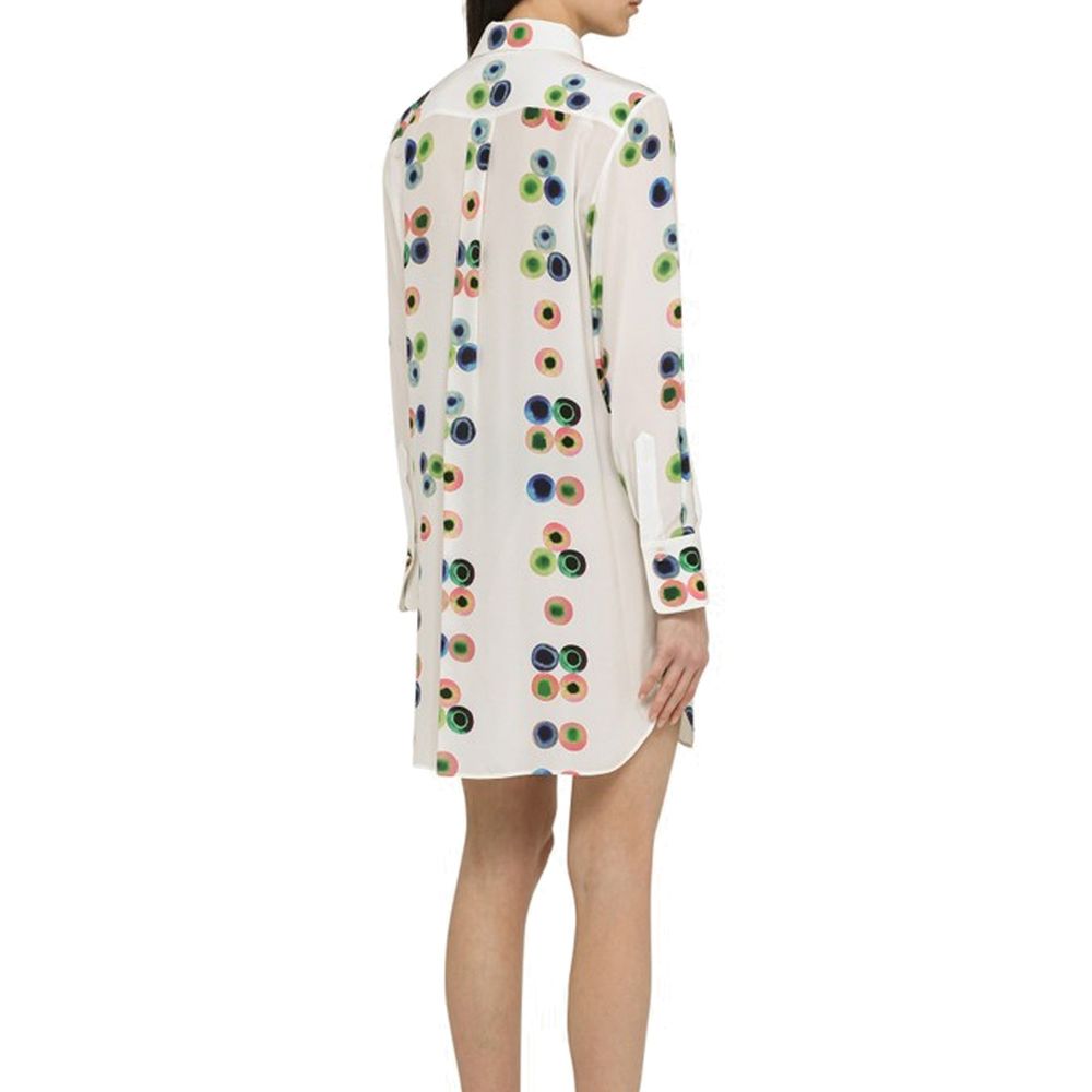 Model wearing multicolor printed Chloé Chemisier Dress with long sleeves, curved hem, 100% silk, front button closure, made in Italy.