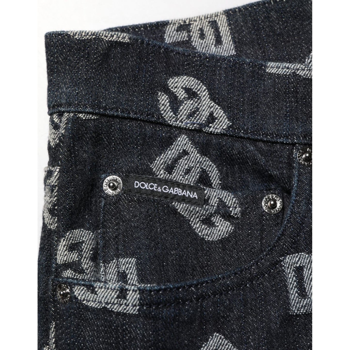 Close-up of Dolce & Gabbana Black DG Monogram Cotton Skinny Denim Jeans with logo detail on pocket and luxury branding design.
