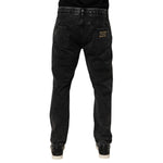 Dolce & Gabbana Black Washed Ripped Loose Cotton Denim Jeans with distressed details and relaxed fit viewed from the back.