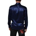 Man wearing Dolce & Gabbana Blue Oversize Silk Satin Long Sleeves Shirt, showcasing the smooth silk back design.
