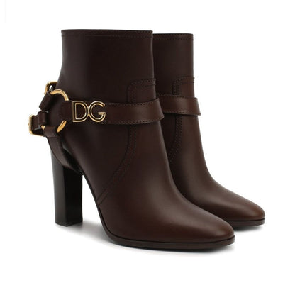 Dolce & Gabbana Brown Leather Ankle Boots with gold logo buckle, zip fastening, and high heel, made from 100% leather. Made in Italy.