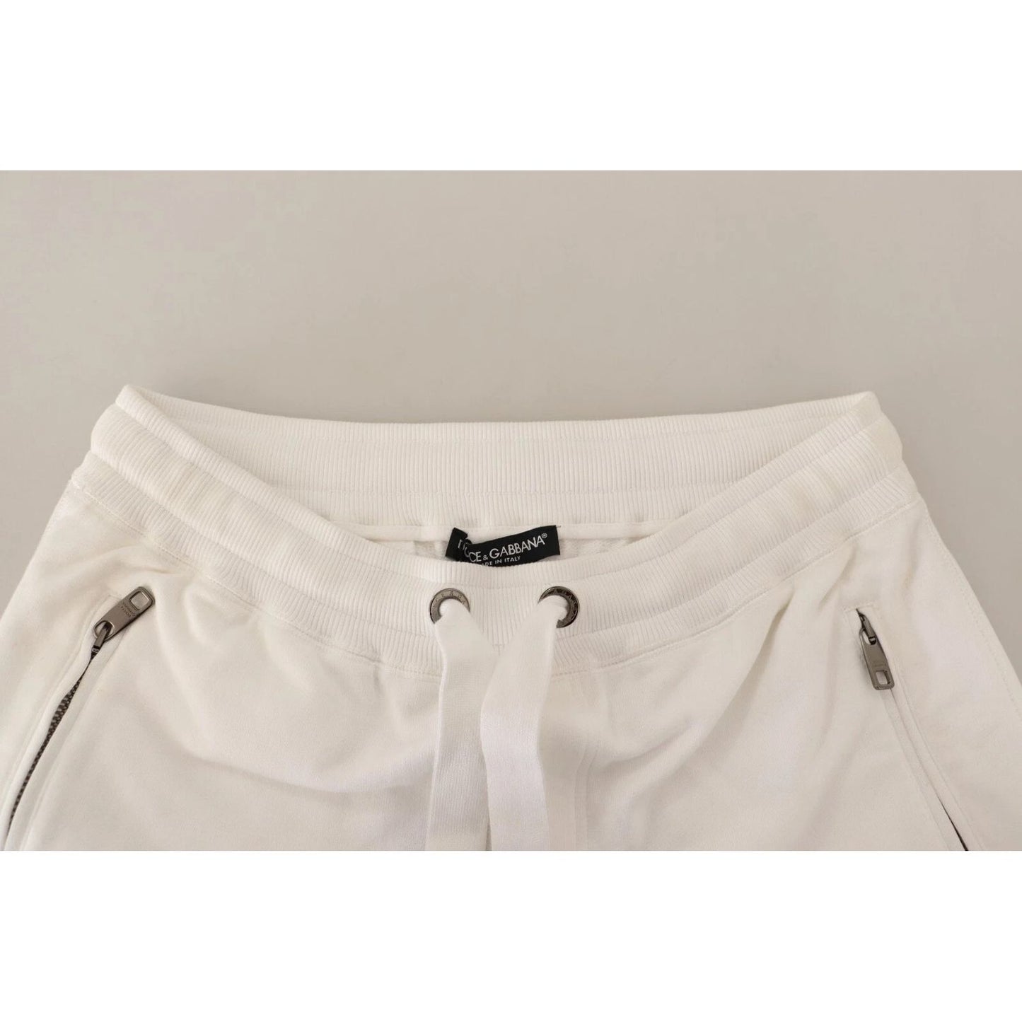 Dolce & Gabbana White Cotton Logo Patch Sweatpants Jogging Pants featuring drawstring closure and zipper pockets, made in Italy.