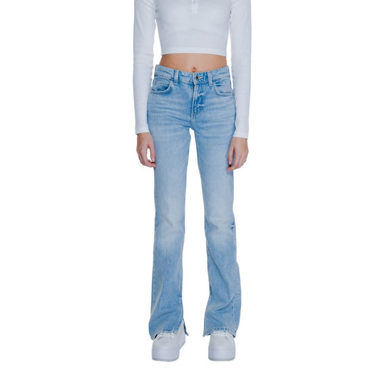 Woman wearing Guess Light Blue Cotton Mom Jeans with flared leg and split hem, styled with a white crop top and sneakers.