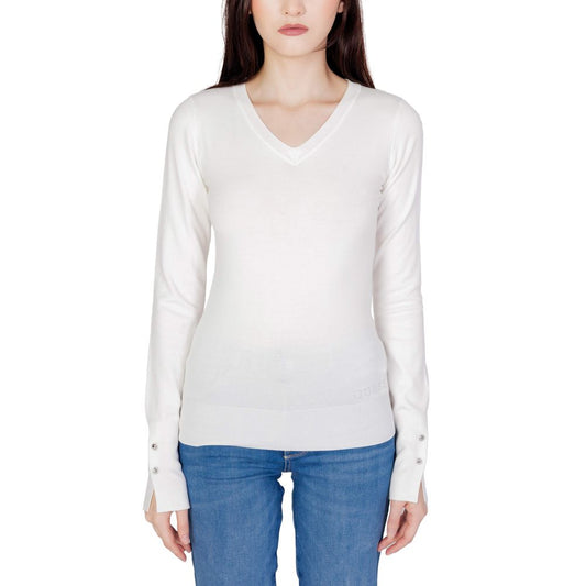 Woman wearing Guess White Cotton Sweatshirt with V-neck and decorative button sleeves, styled with jeans for a versatile look.