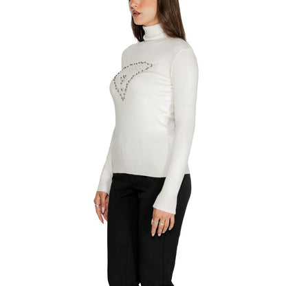 Model wearing Guess White Viscose Turtleneck with embellished logo, showcasing stylish design and comfortable fit.