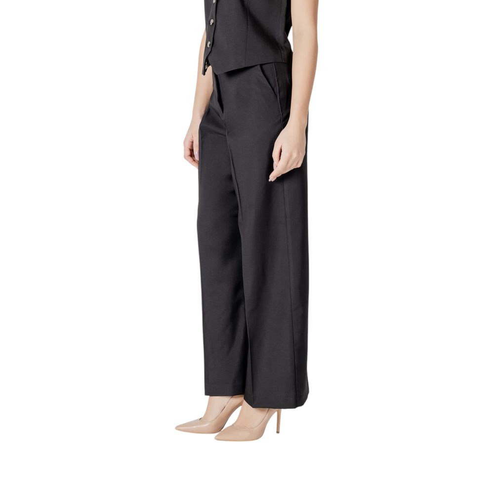 Woman wearing ICHI Black Polyester Pant with wide, flowing cut, showcasing elegant and sophisticated palazzo trousers for modern style.