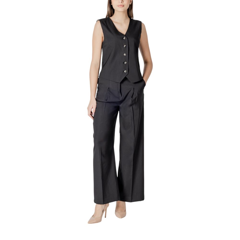 Woman wearing ICHI Black Polyester Pant palazzo trousers, showcasing elegant wide-leg design and refined front pleats.