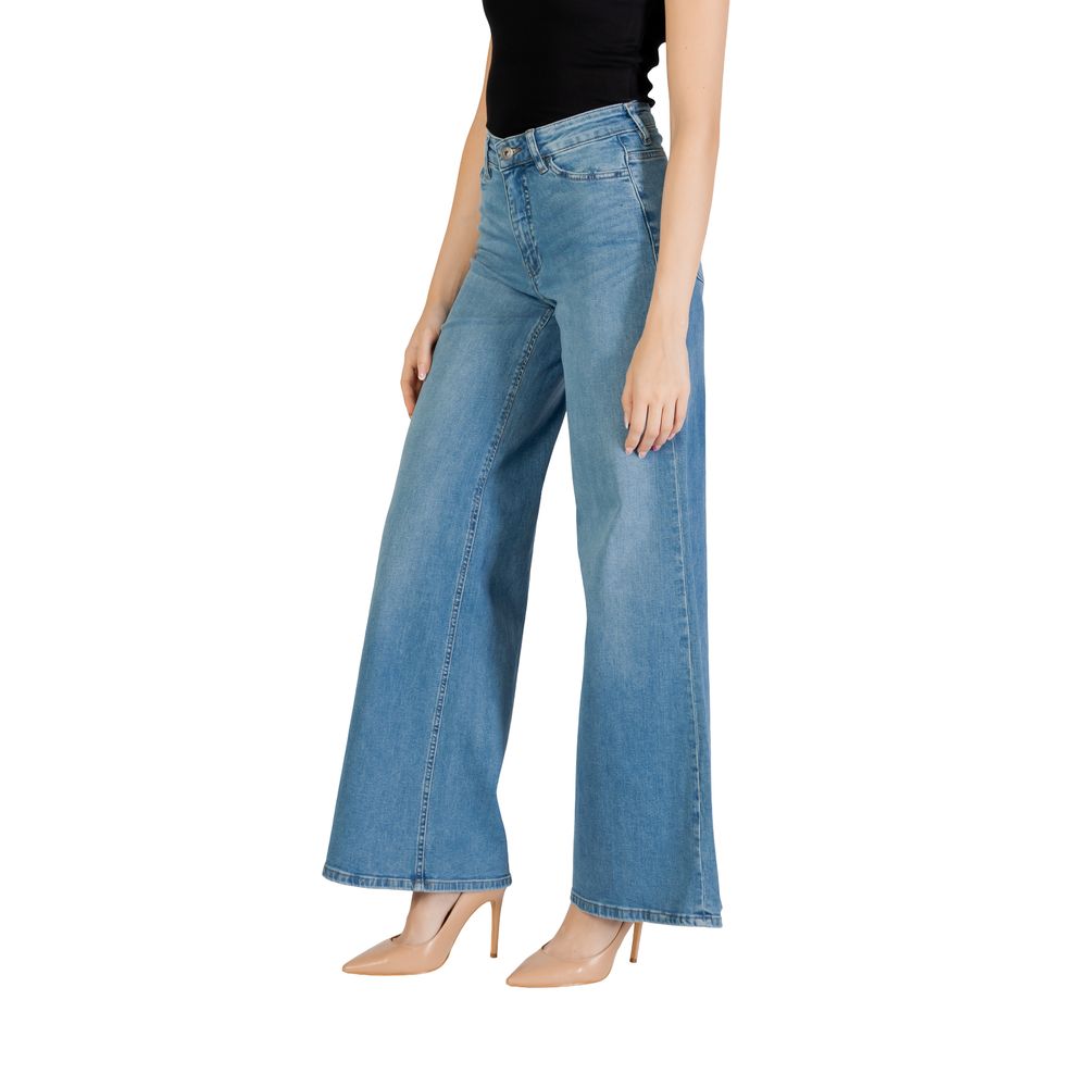 Woman wearing ICHI Light Blue Cotton Bootcut Jeans, showing wide-leg cut and regular waist for a flattering silhouette.