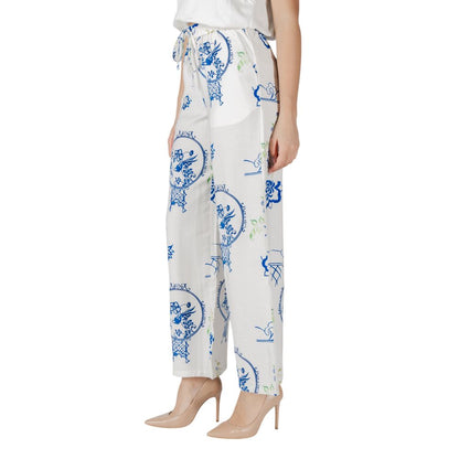 Model wearing ICHI White Viscose Pant with unique blue print design, showcasing wide-leg fit and breathable fabric, ideal for warm weather.