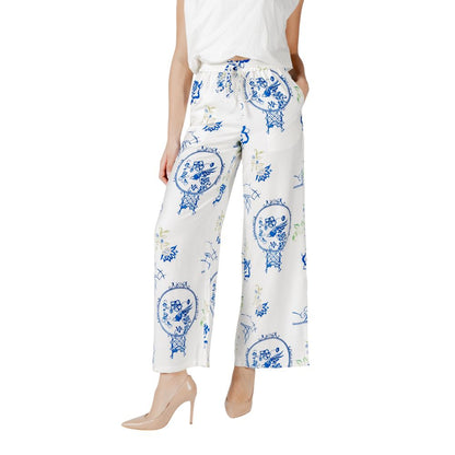 Woman wearing ICHI White Viscose Pant with floral design, wide-leg style, ideal for casual chic or formal occasions, perfect in warm weather.