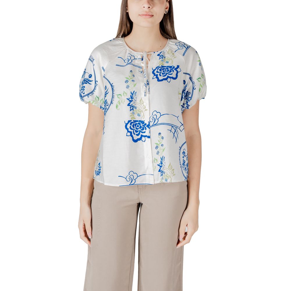 Woman wearing blue floral blouse with short sleeves