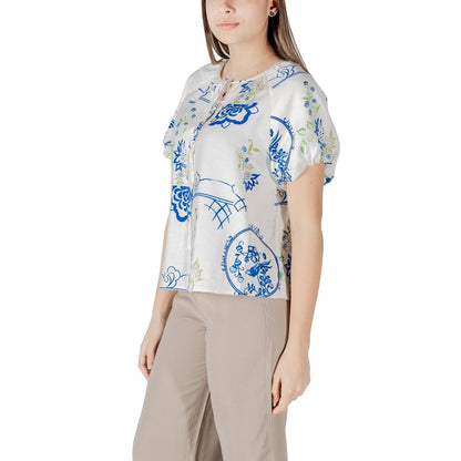 Woman wearing ICHI White Viscose Shortsleeve shirt with blue patterns, ideal for summer, showing front detail and short sleeves.