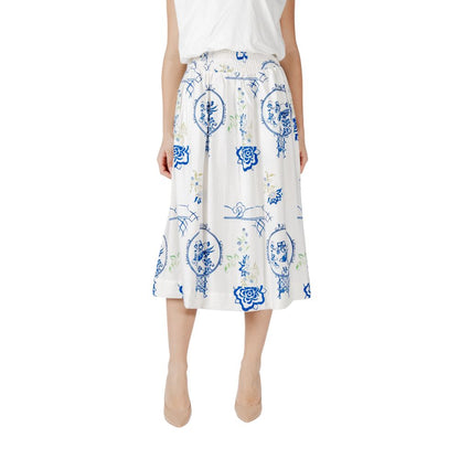 Woman wearing ICHI White Viscose Skirt with blue floral patterns, showcasing elegant and versatile summer fashion.