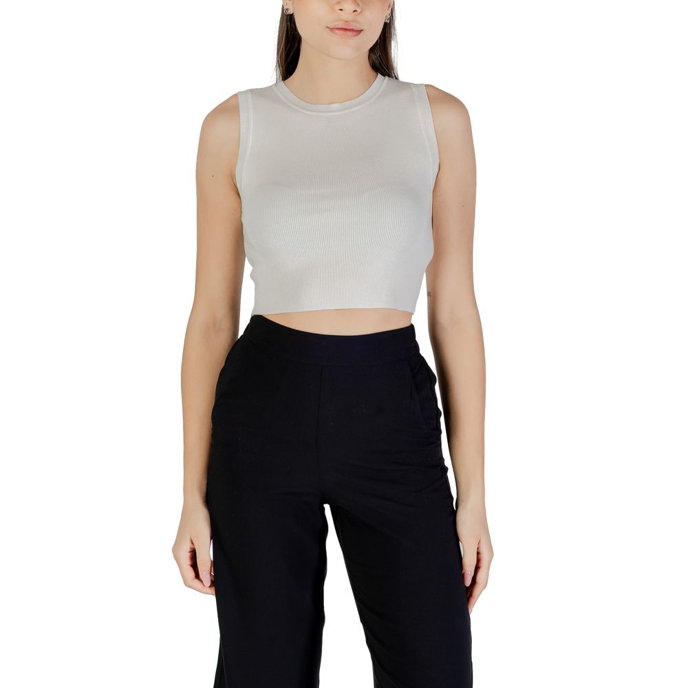 Jacqueline De Yong White Viscose Tank Tops on model with black trousers, showcasing sleeveless cropped design.