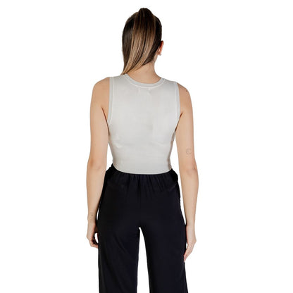 Back view of woman wearing Jacqueline De Yong White Viscose Tank Tops paired with black pants.