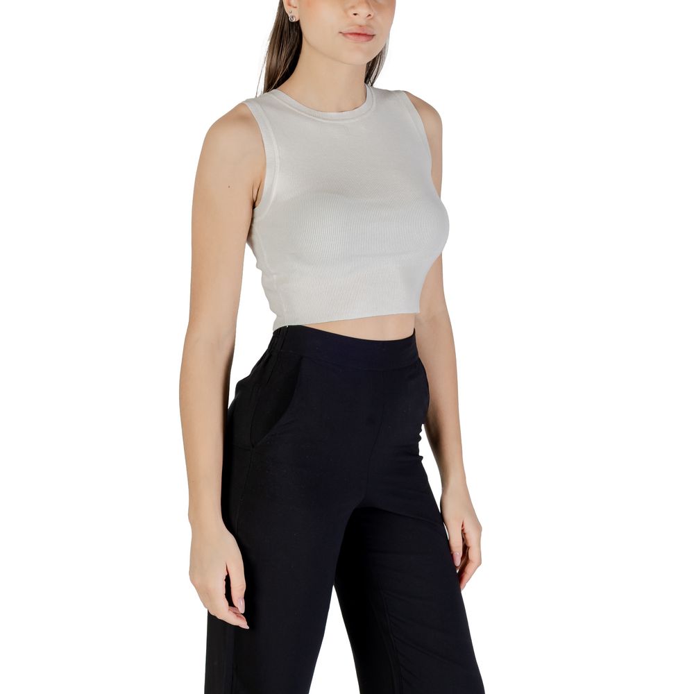 Jacqueline De Yong White Viscose Tank Tops on model, elegant cropped design, styled with black trousers for a chic summer look.